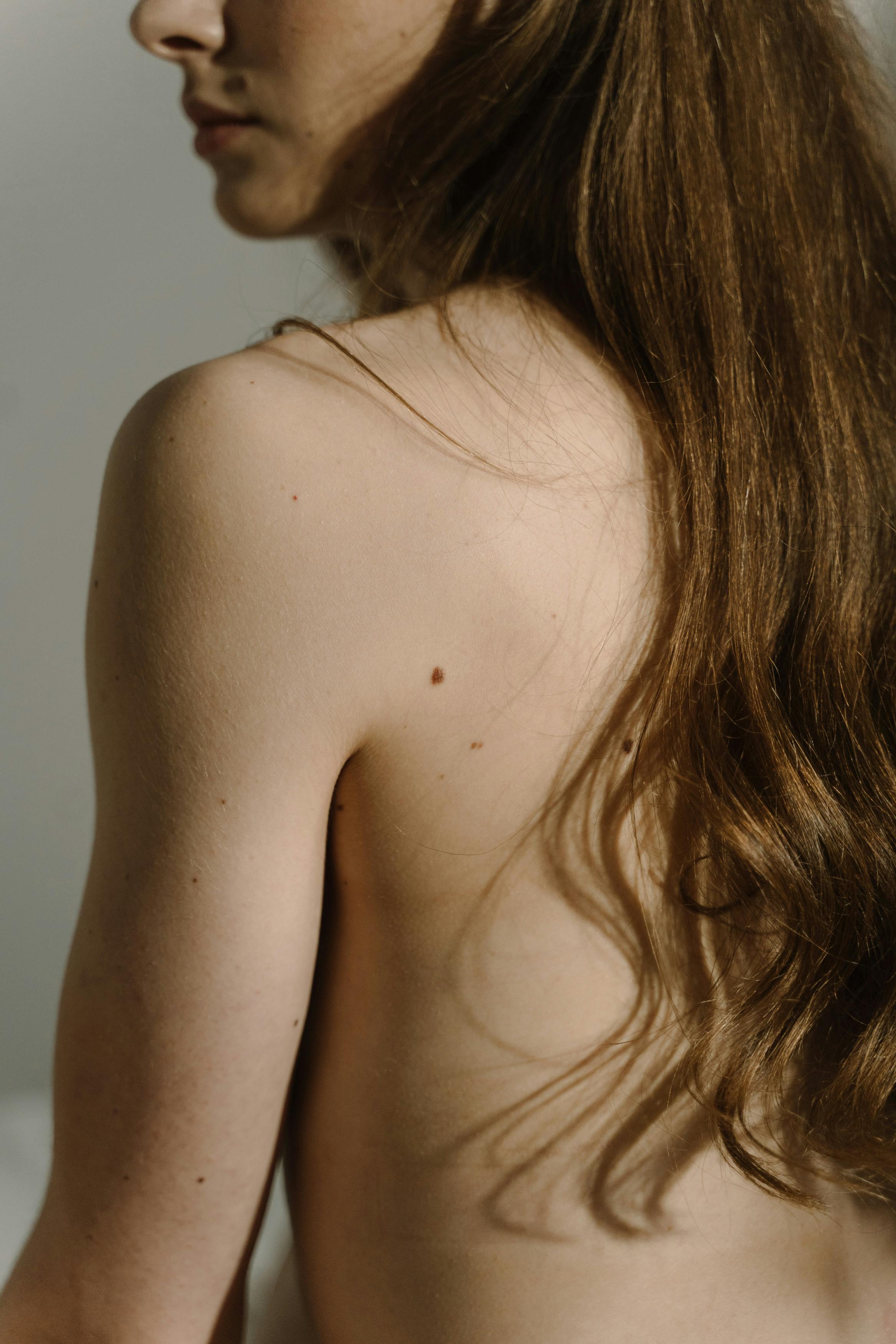 close up photo of woman s shoulder