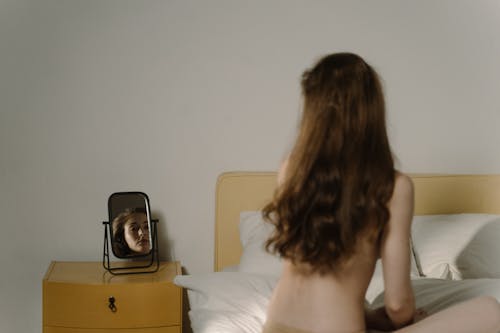 Backview Photo of Woman sitting in Bed 