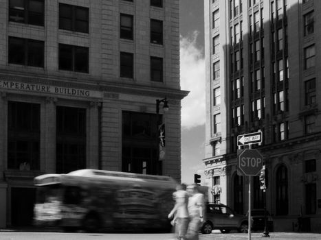 Black-and-white urban street scene in Portland, ME featuring classic architecture and motion blur.