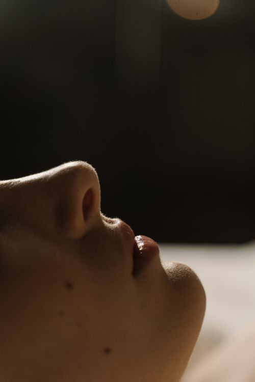 Extreme close-up of a person's nose and lips in side profile — rhinoplasty reference view