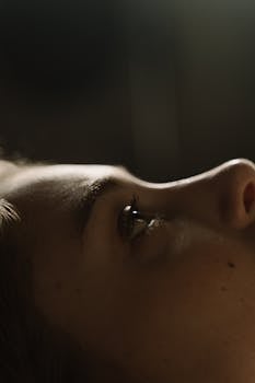 A close-up shot of a woman's face lying down, capturing emotion and detail.