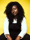 Black woman with curly hair on yellow background