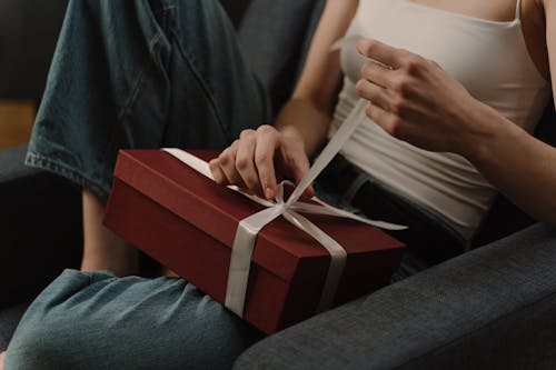 Free A Person Opening a Gift Stock Photo