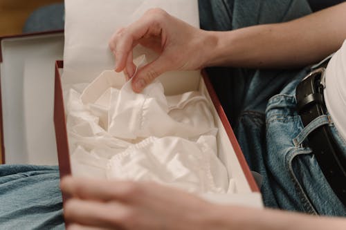 Hand Touching a White Fabric 