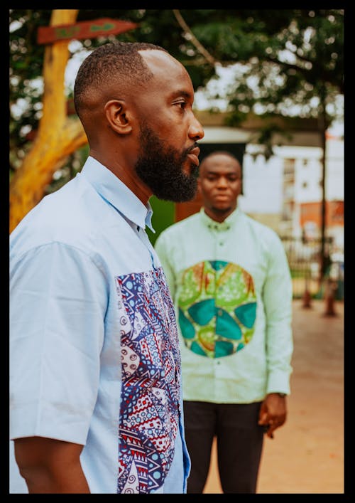 Free African men in colorful shirts on street Stock Photo