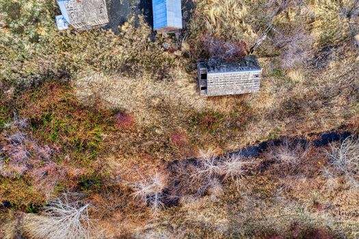 Aerial photography of abandoned houses amidst dry vegetation in Pendleton, Oregon.