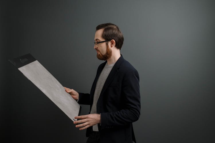 Man Looking At Gray Paint Sample