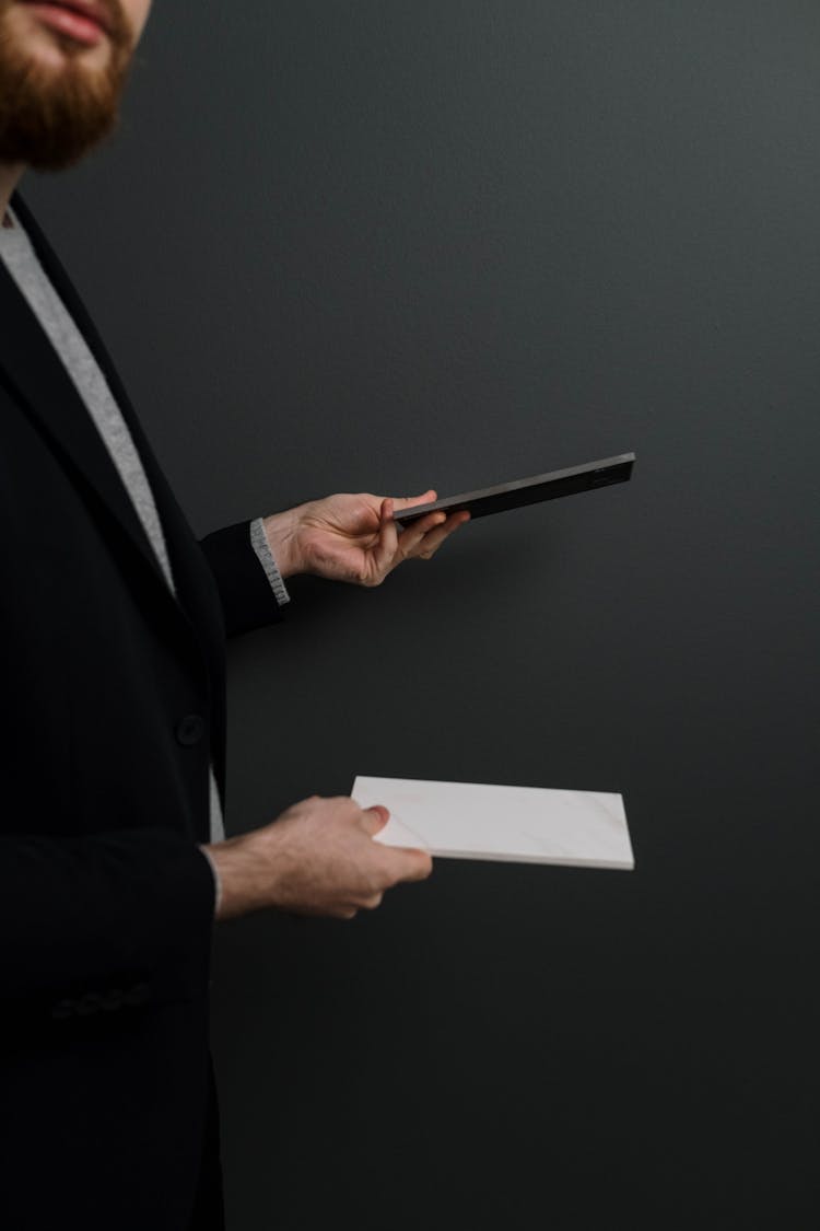 A Man Holding Tile Samples