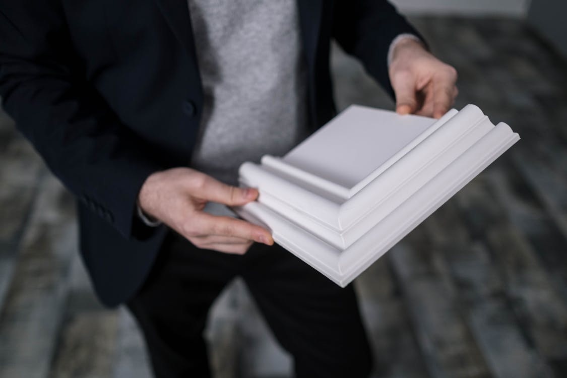 A Person Holding a Cornice Sample