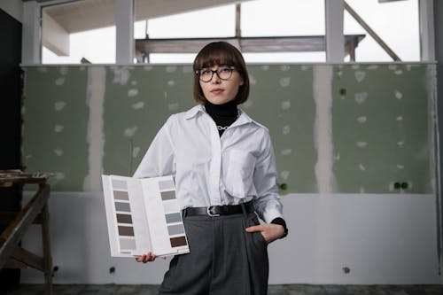 A Woman Posing with a Catalog of Color Samples