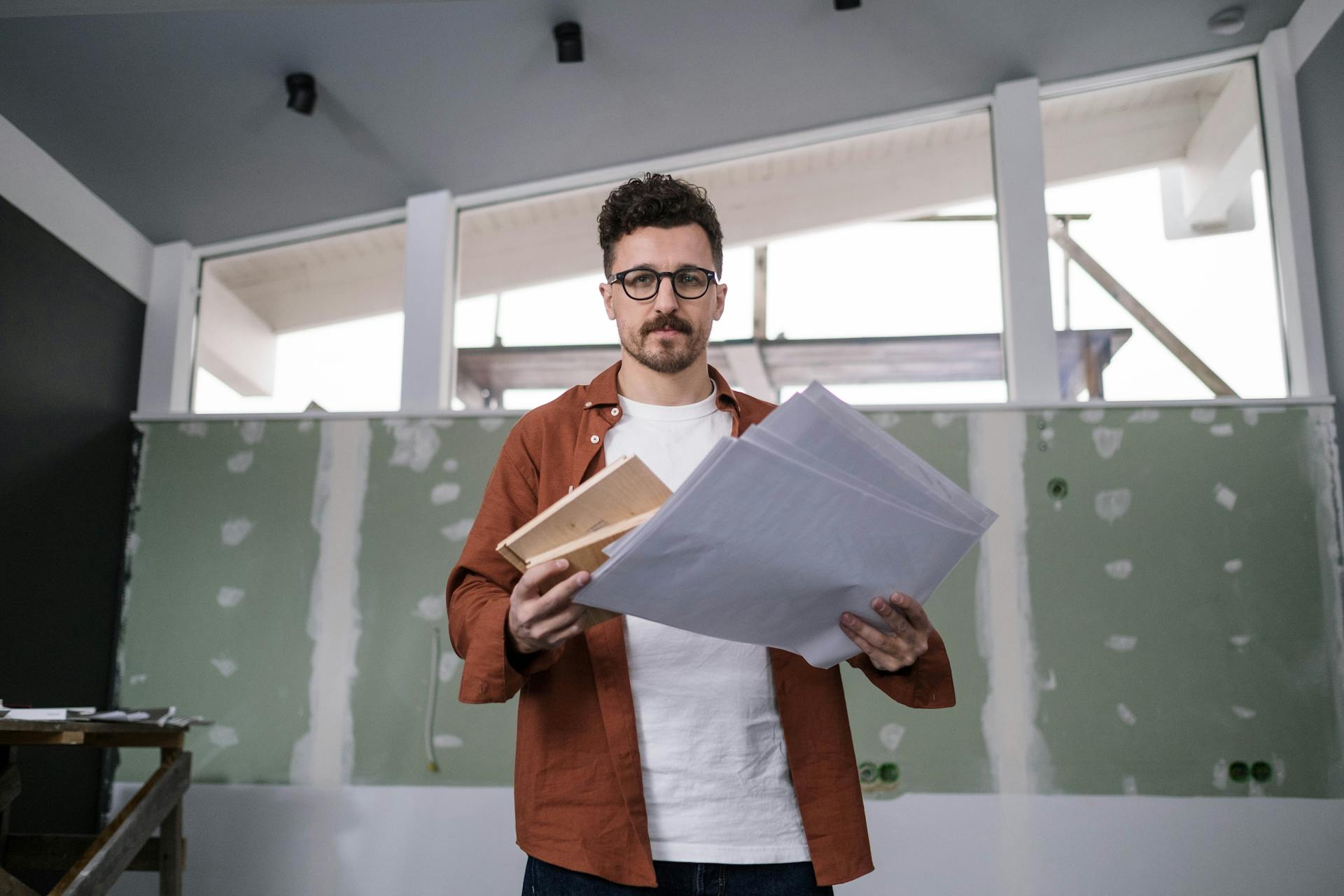 A Man Holding Papers and Documents