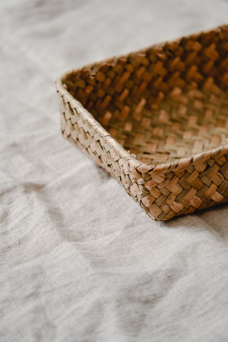 A Woven Basket On Linen