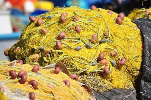 Free Close-up of vibrant yellow fishing nets with floats in Samos, Greece, showcasing traditional fishing equipment. Stock Photo