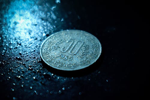 Close-Up Photo of Wet Coin