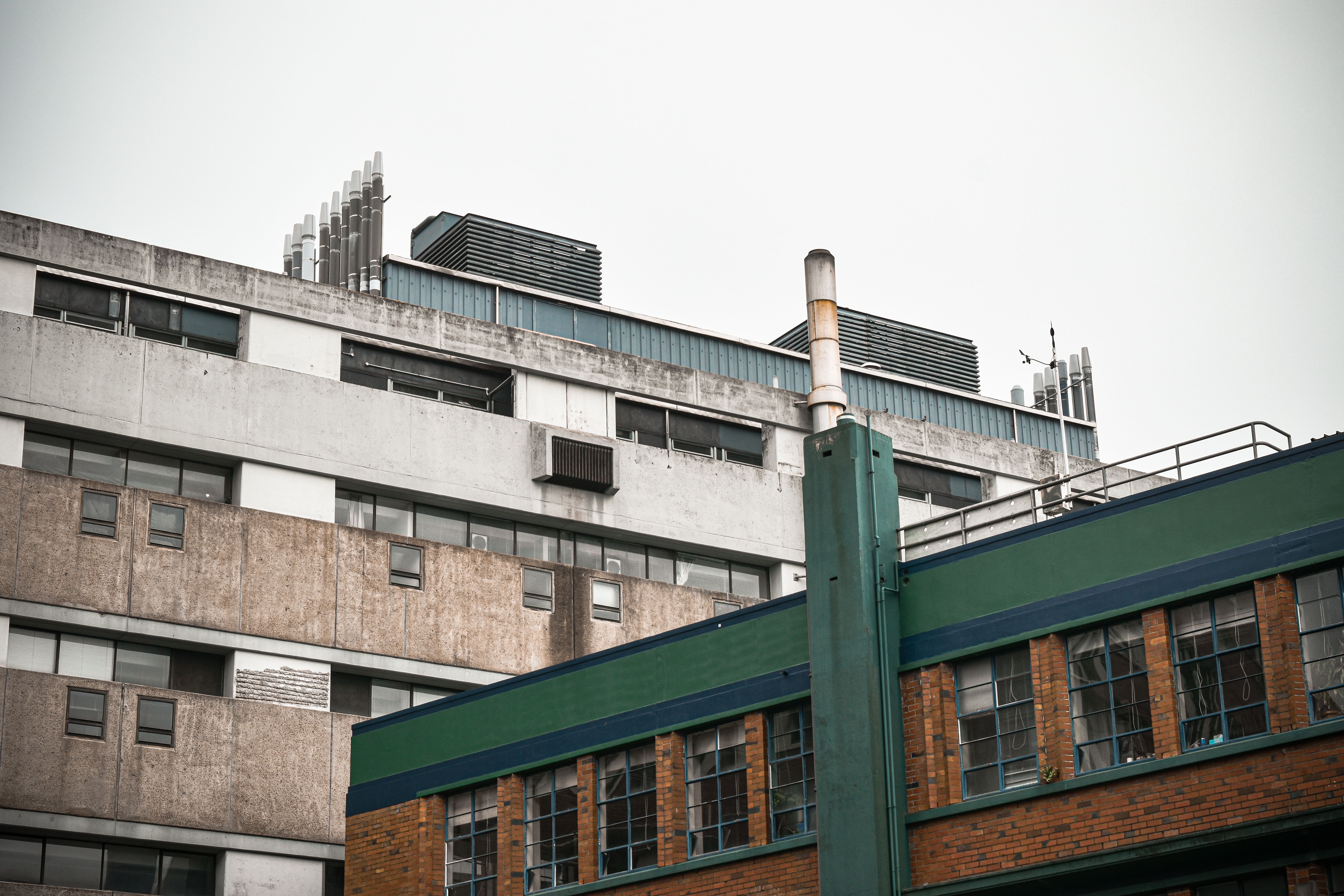 Exterior view of modern urban building showcasing industrial design with chimneys and facade details.