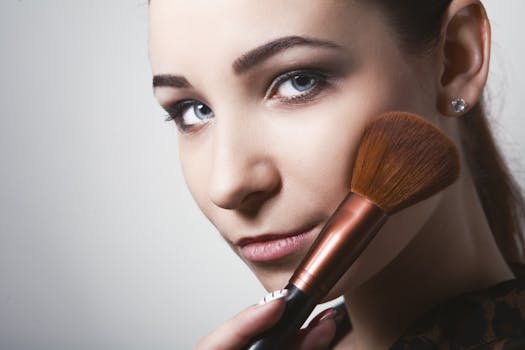 Close-up view of a young woman using a makeup brush, showcasing beauty and cosmetics.