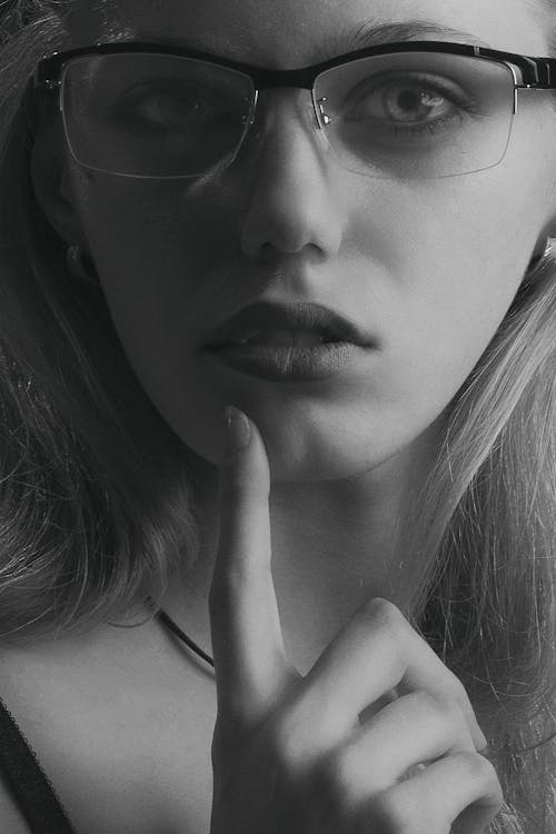 Grayscale Photo of a Woman With Eyeglasses 