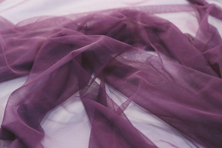 A Purple Chiffon Fabric On White Surface