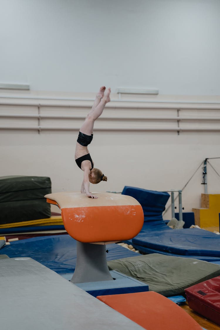 A Girl Doing A Handstand On A Vaulting Table