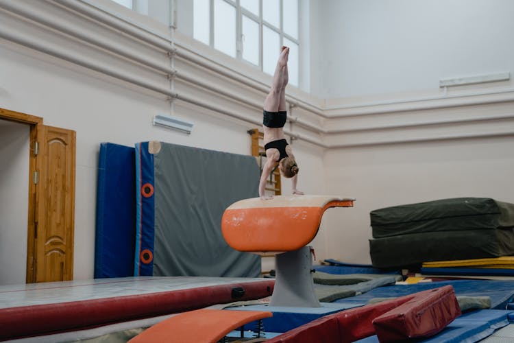 A Girl Doing A Handstand On A Vaulting Table