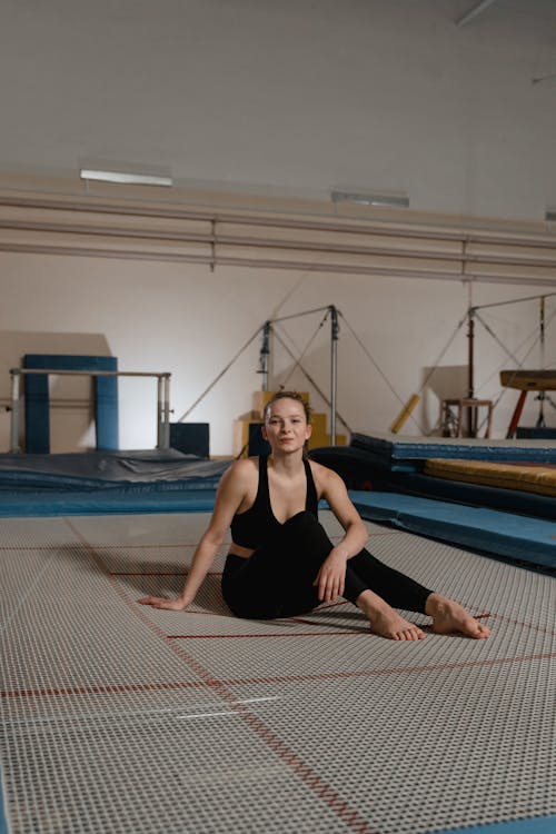 A Young Woman in Activewear Sitting on the Floor