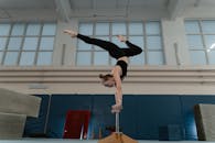 A Gymnast Doing a Handstand on a Handstand Cane