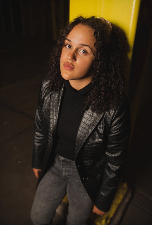 Portrait of a Young Woman with Curly Hair and a Leather Jacket