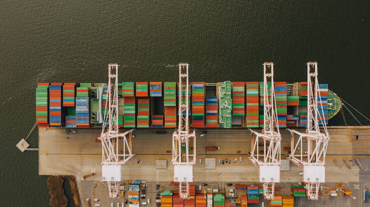 Colorful Cargo Containers On Ship Near Pier