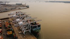 Lifting cranes loading ship with cargo containers
