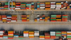 Many different bright cargo containers on asphalt