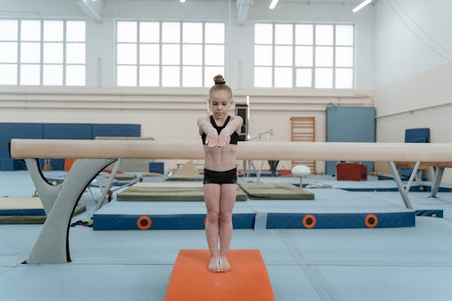 Free A Little Girl Training in a Gymnastics Gym Stock Photo