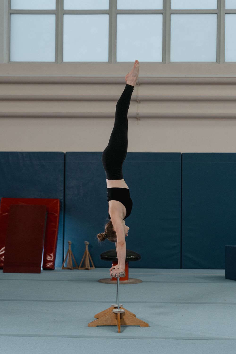 Contortion Balancing Woman Doing Arm Balance on Contortion Equipment · Free Stock Photo