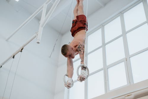 Free Man Upside Down on Gymnastic Rings Stock Photo