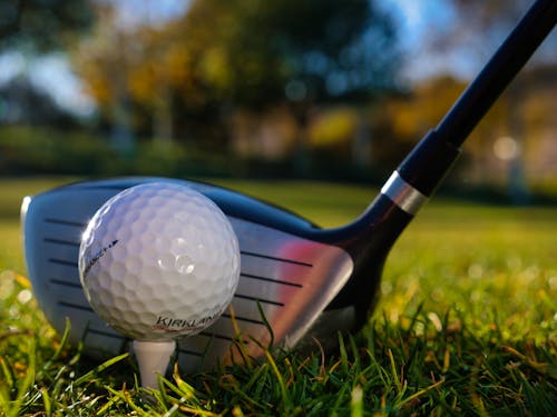 A Golf Ball and Golf Club in Close-Up Photography