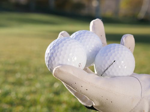 Three White Golf Balls