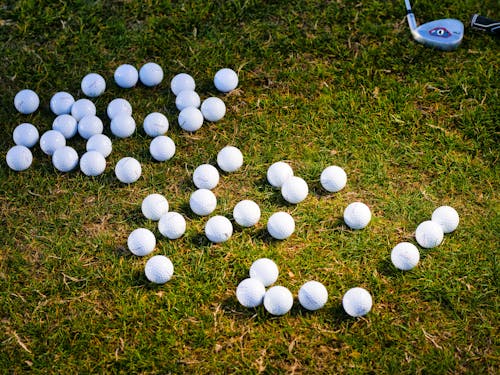 White Golf Balls on Grass