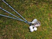 Golf Irons and Balls on Green Grass Field