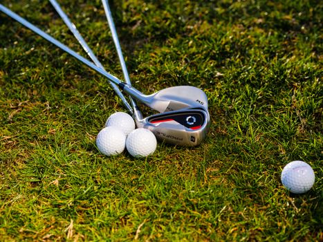 Golf Balls and Golf Clubs on Green Grass