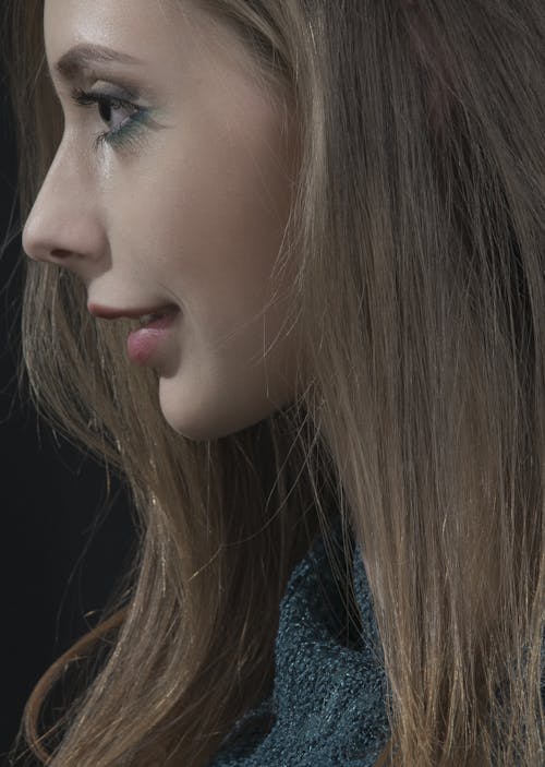 Side View of a Woman in Close Up Photography 