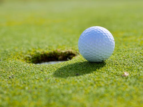Free Close Up Photo of Golf Ball near a Hole Stock Photo