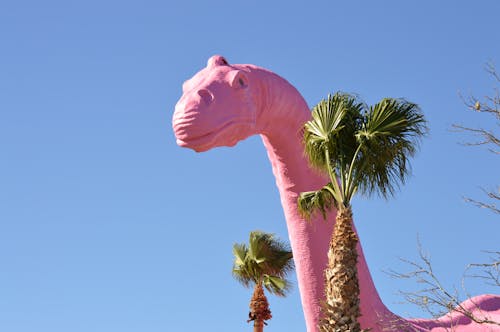 Inflatable Dinosaur between Palm Trees