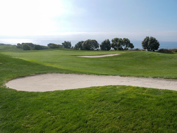 Photo Of Golf Course Under Blue Sky