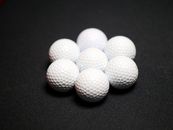 Set of golf balls on black background