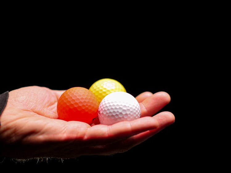 Golf Balls On A Hand 