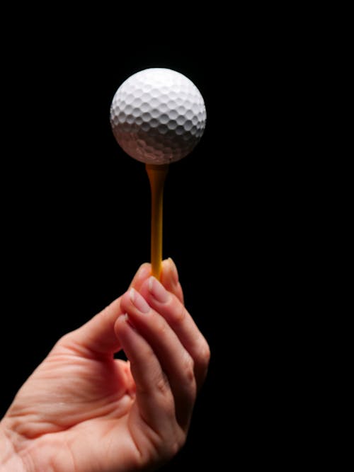 Person Holding Golf Tee with Golf Ball