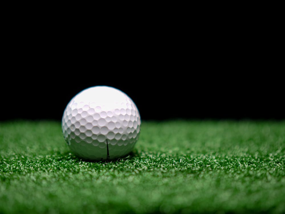 A Golf ball placed on artificial grass