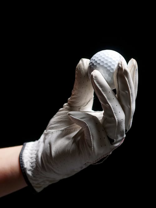 A Person Holding a Golf Ball 