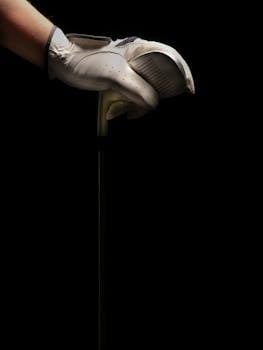 Close-up of a white gloved hand gripping a golf club against a dark studio background.