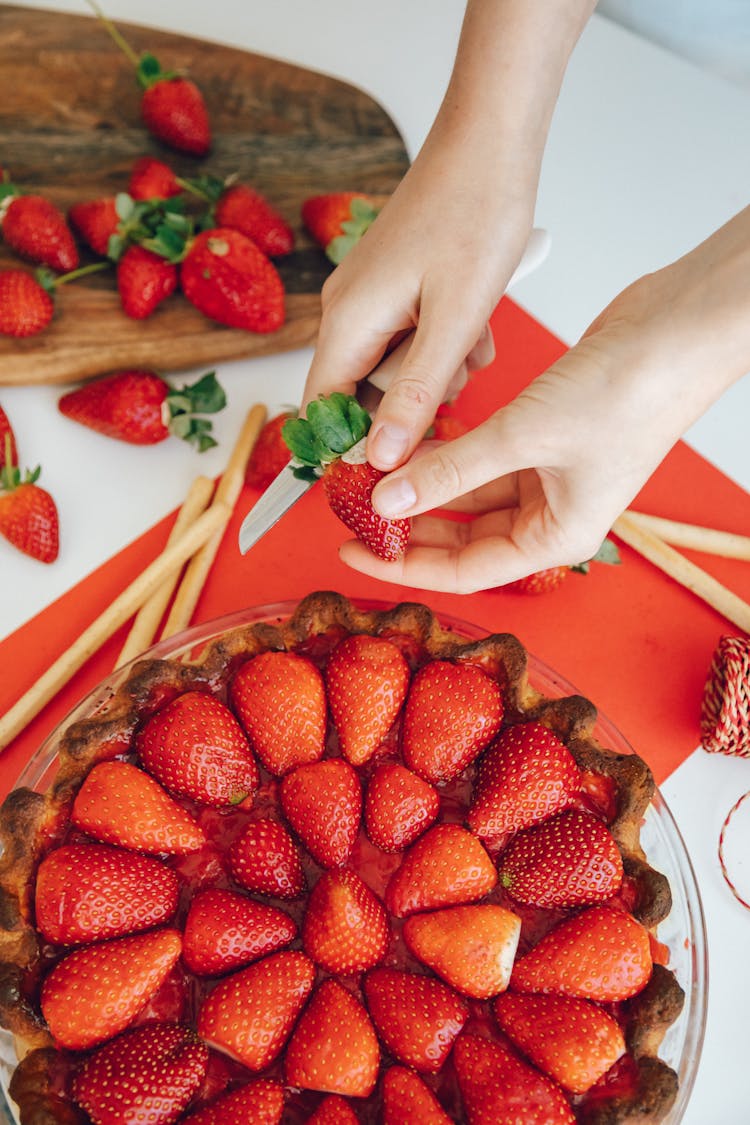 Person Holding A Knife And Strawberry