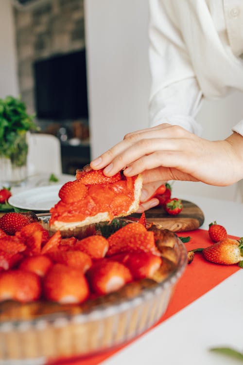 Free Person Holding a Sliced of Strawberry Pie Stock Photo
